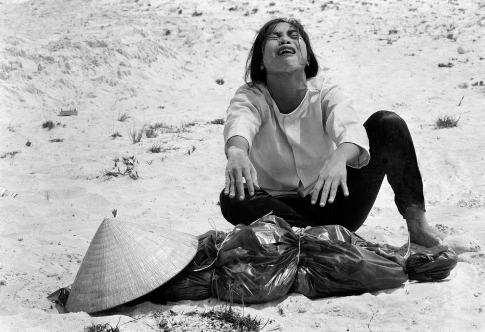 A South Vietnamese woman mourns over the body of her husband, fo